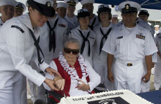 Sybil Stockdale cutting a cake on POW/MIA Day in 2011. Navy photo