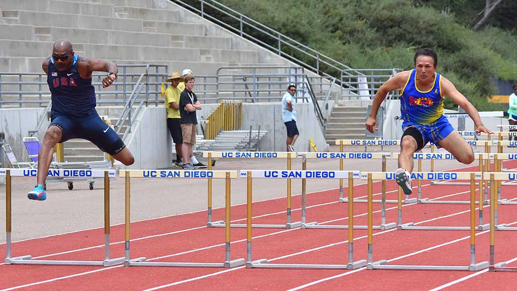 Robert McDaniels and Mahmoud Niroumand, both 60, battled in the 100-meter hurdles, with McDaniels (left) winning in 16.84 seconds. Photo by Ken Stone