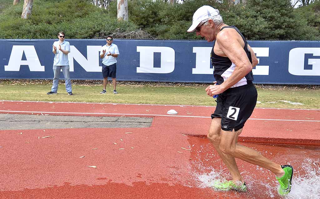 Volunteers at the steeplechase applaud A.J. Underwood, 79. Photo by Ken Stone