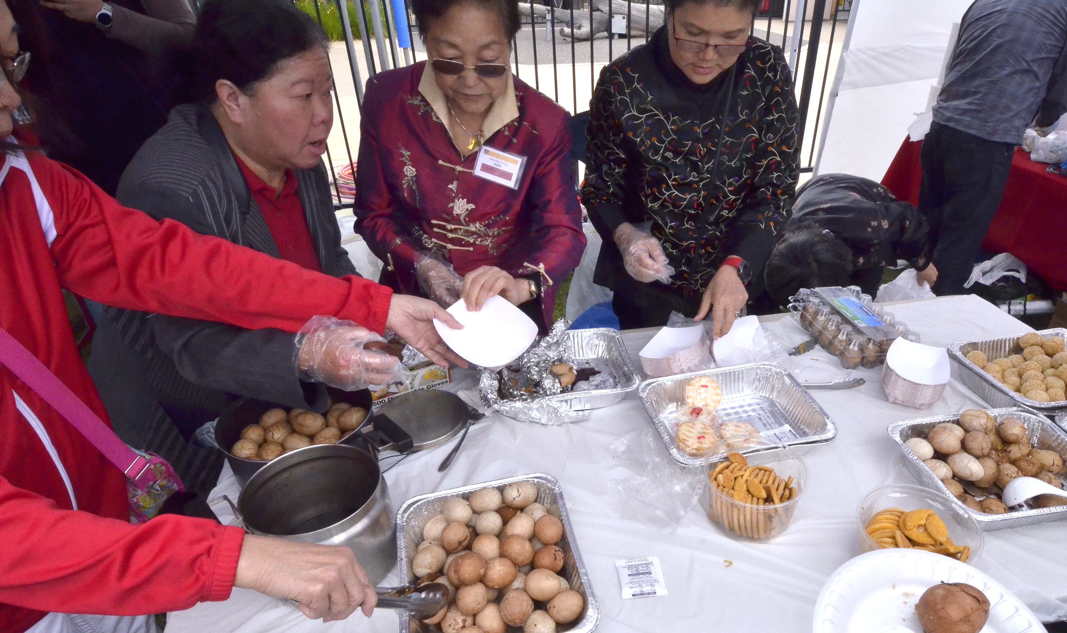Tea eggs, sesame balls and almond cookies were offered by the Chinese community.