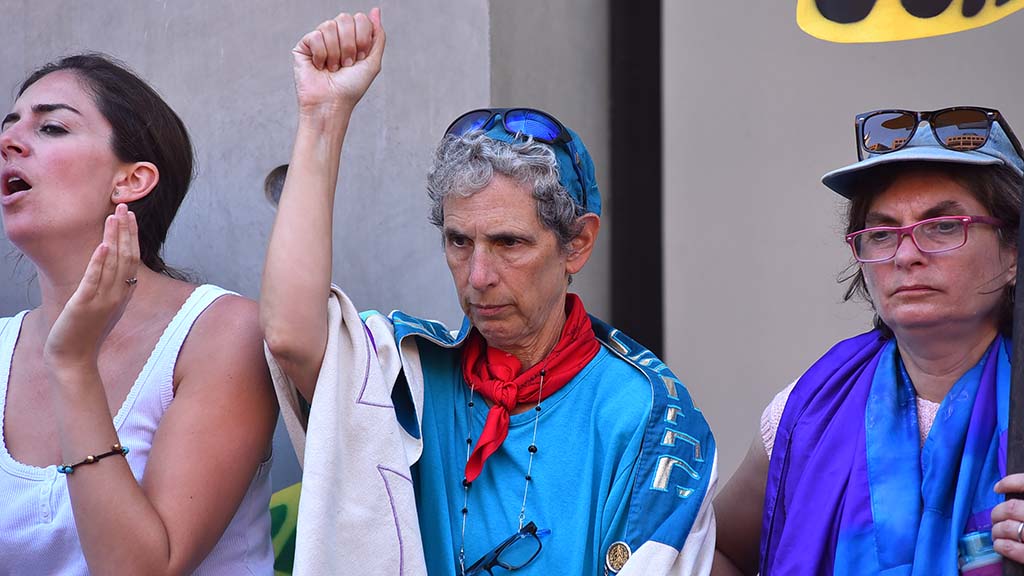 Rabbi Shifrah Tobacman of the San Francisco Bay Area (center) responds to a speech in downtown San Diego.