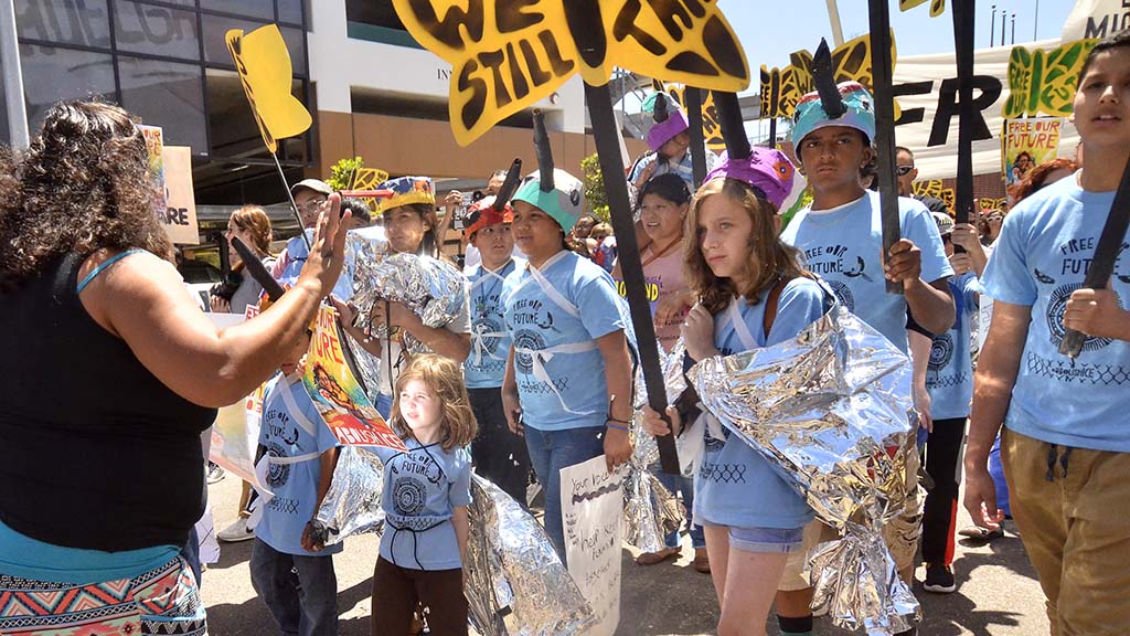 Children, some draped in mylar blankets, led the march down National Avenue toward downtown.
