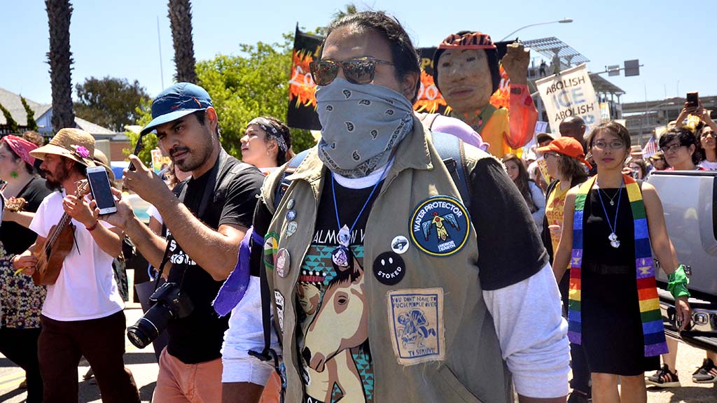 Hundreds of marchers walk downtown to the federal building.
