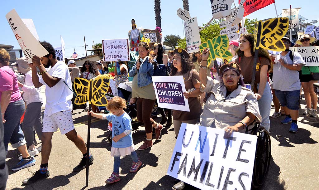 Hundreds of marchers walk downtown to the federal building.