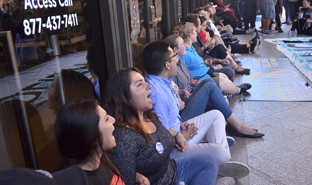 Protestors block the entrance to the Edward J. Schwartz Courthouse. Employees used the emergency exit for entrance.