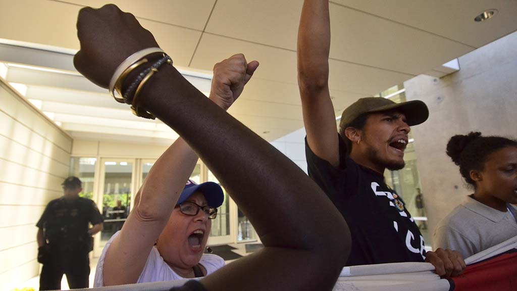 Protesters block the entrance to the James M. Carter and Judith Keep Courthouse.