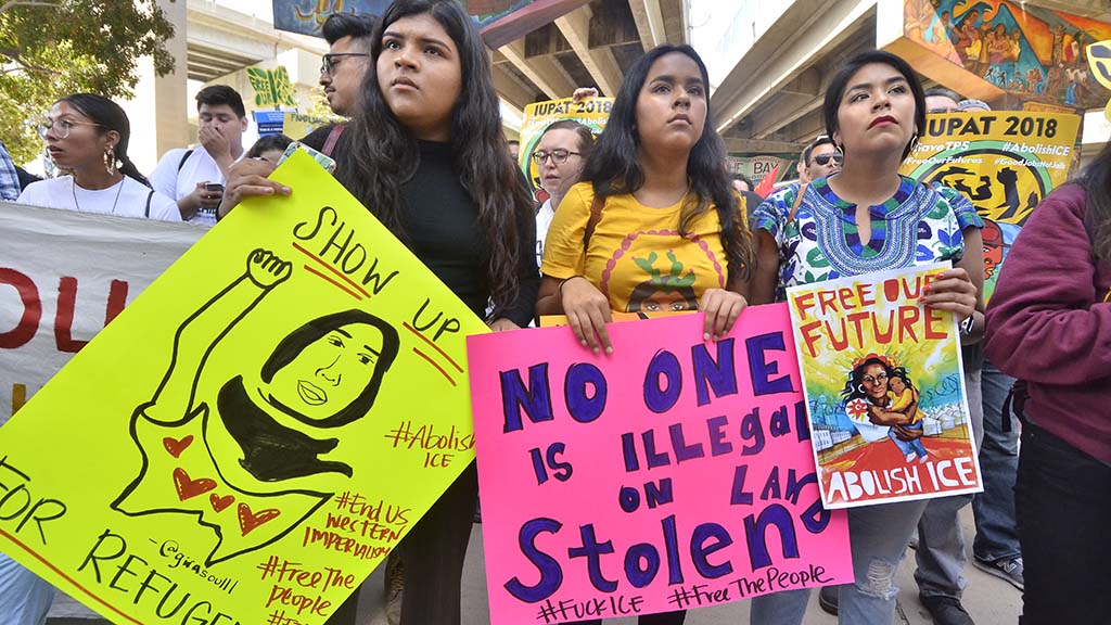 Protesters listen to speakers in Chicano Park before the march to downtown San Diego.