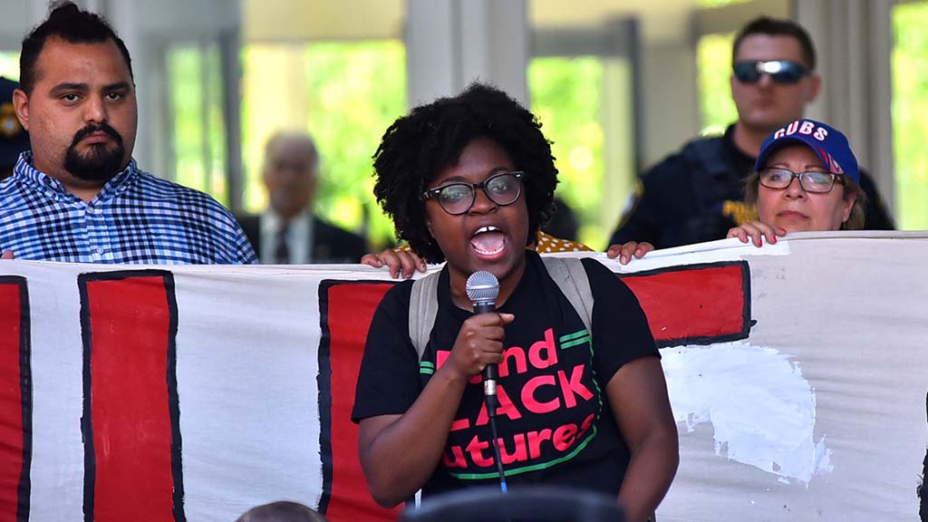 Charlene Carruthers of the Black Youth Project 100 in Chicago speaks in front of a blockage in front of a courthouse.