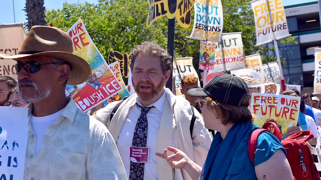 A member of Jews for Racial and Economic Justice wore a sticker saying "Resisting tyrants since Pharaoh."