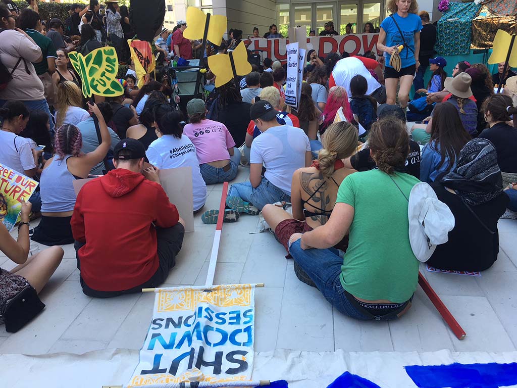Dozens taking part in sit-down protest at San Diego federal building.