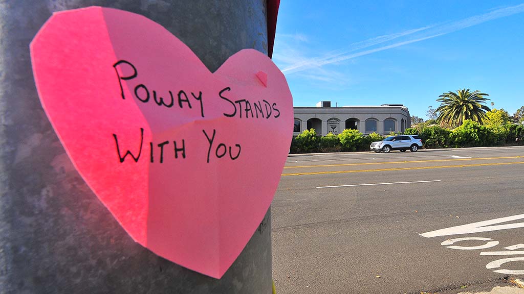 A neighborhood family placed hearts with supportive messages across the street from Chabad of Poway.