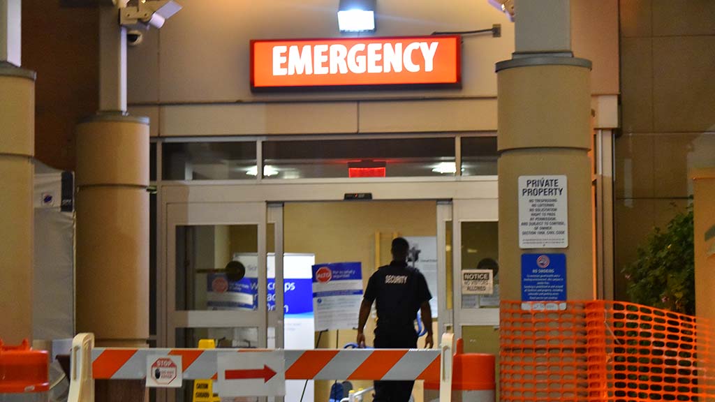 A security officer enters the Scripps Mercy Hospital San Diego emergency entrance.