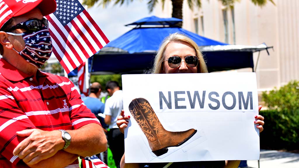 A simple sign made the point. Woman wants Gavin Newsom to get the boot.